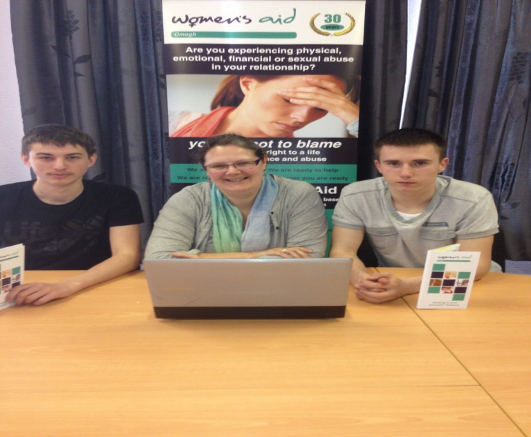 Orla Conway of Omagh Women's Aid with Andrej Boldiss and Benjamin Aranyi from Sacred Heart Secondary school