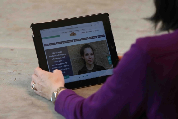 Woman looking at domestic violence website on ipad