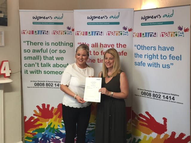 Michelle O'Neill presents Helpline staff member Kathleen with her NOCN Domestic & Sexual Violence Practitioner certificate