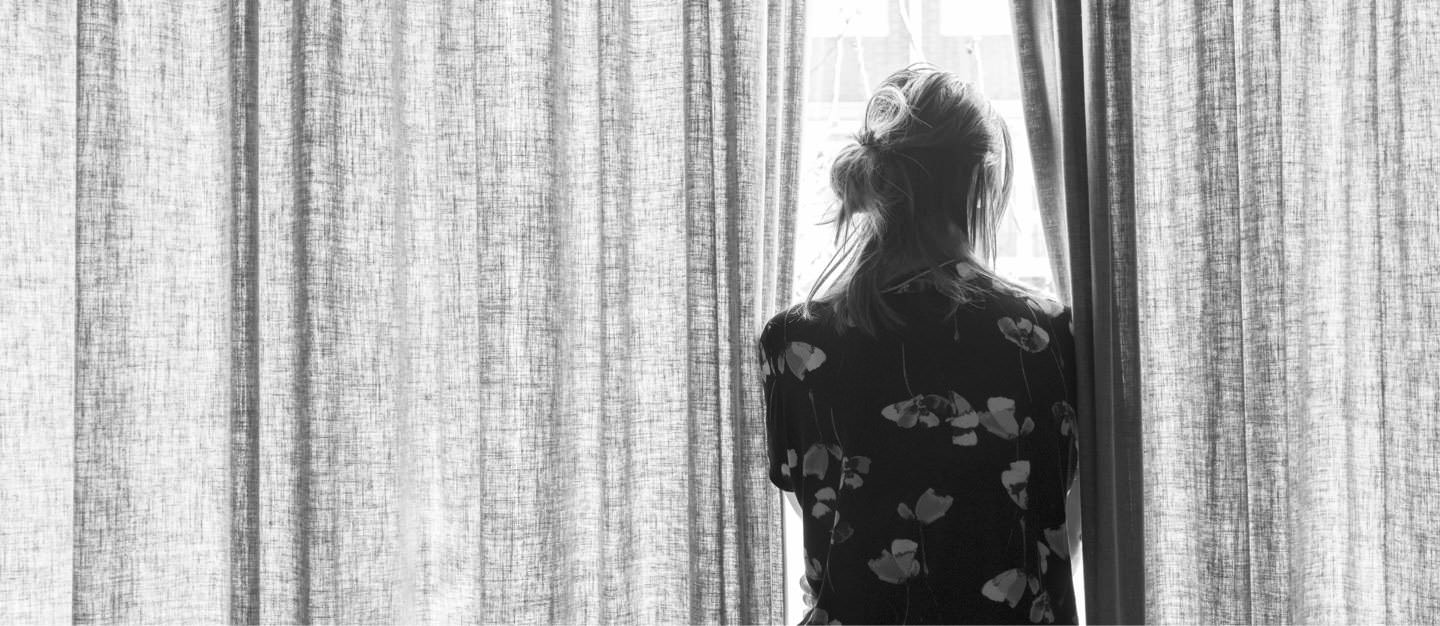 Woman Looking Out Of Window