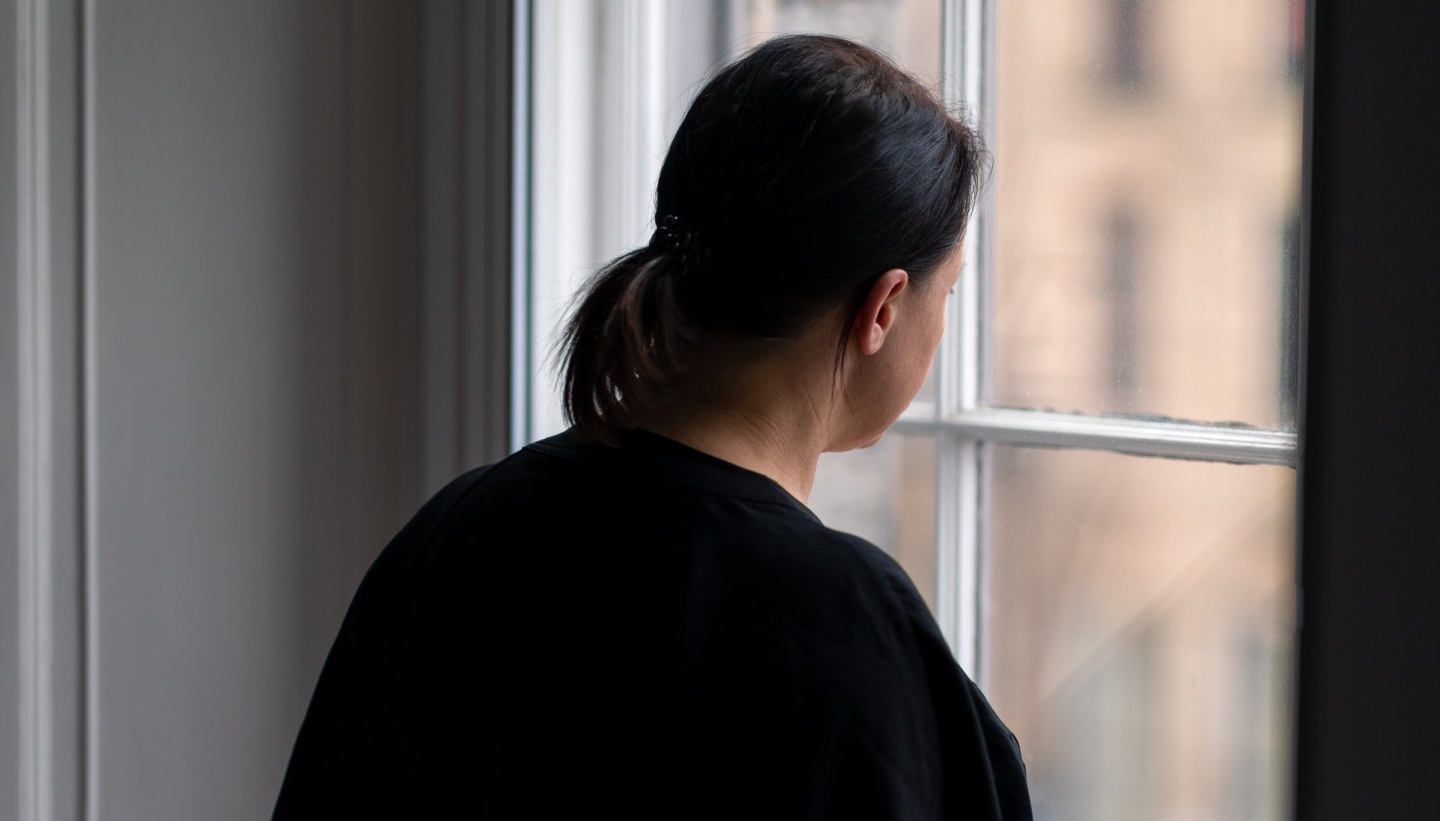 Woman Looking Out Window