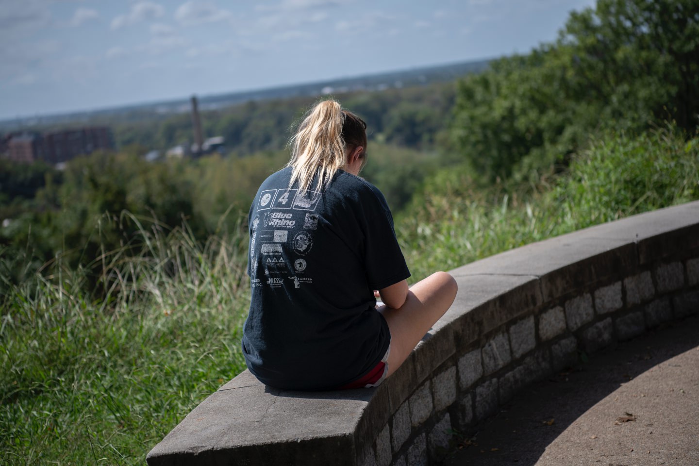 Young Girl Sitting On Wall