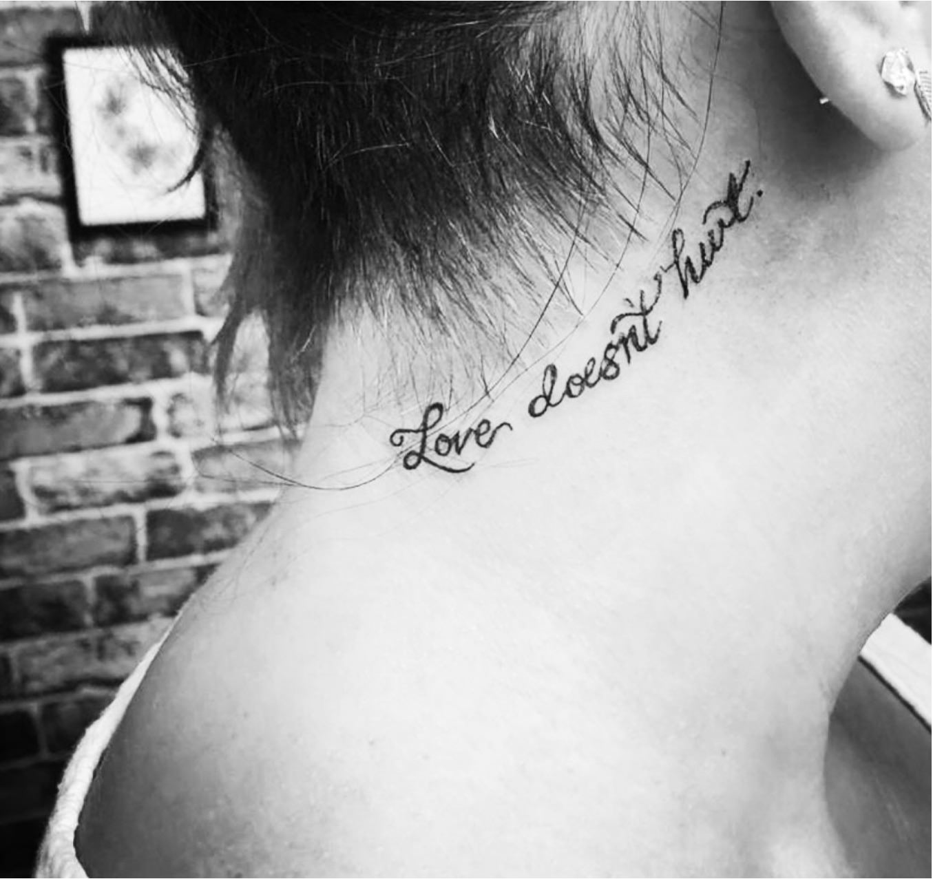 Love doesnt hurt tattoo on back of women's neck